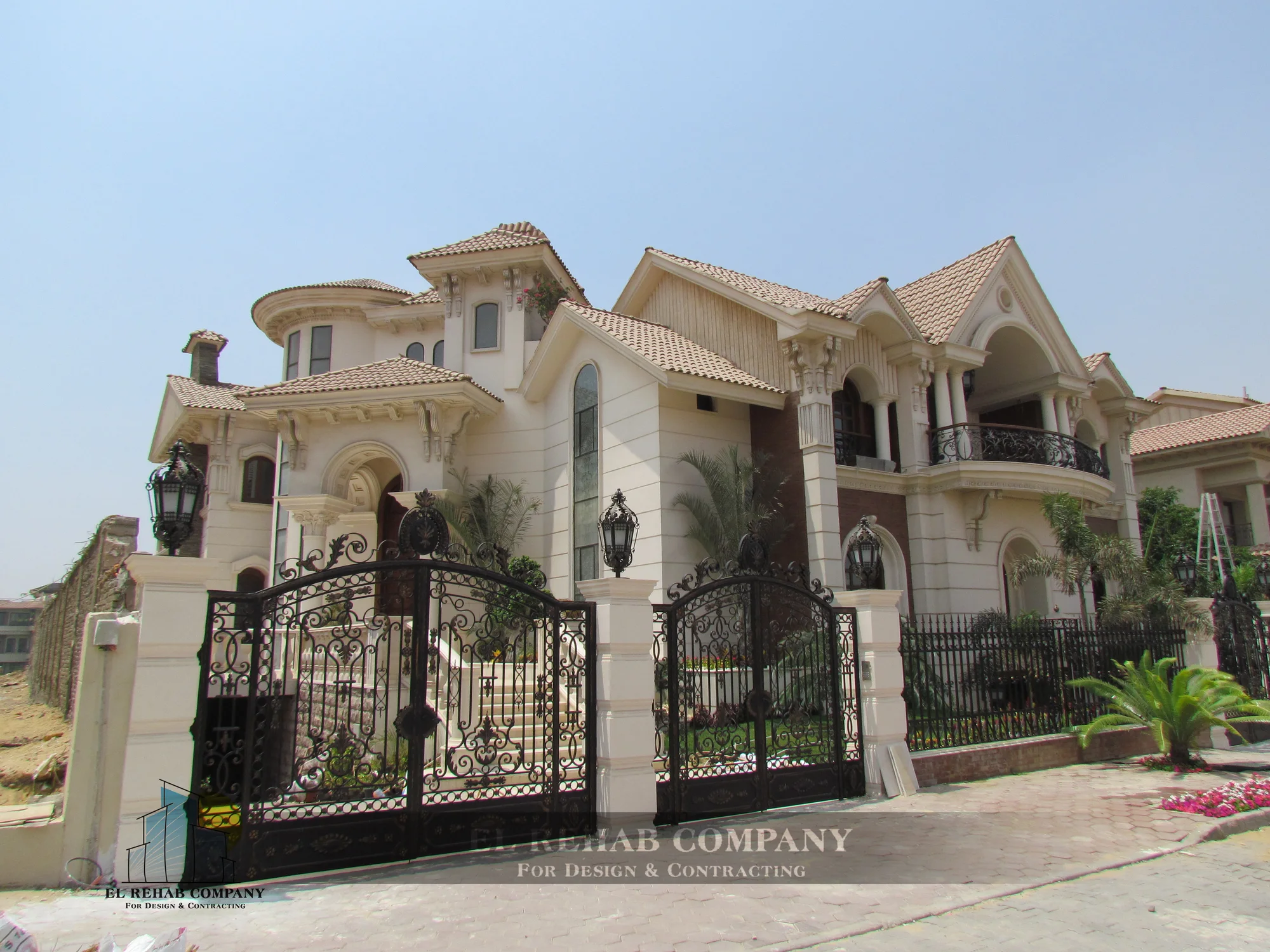 Completed Mirage City villa with a classical facade and ornamental entrance gates